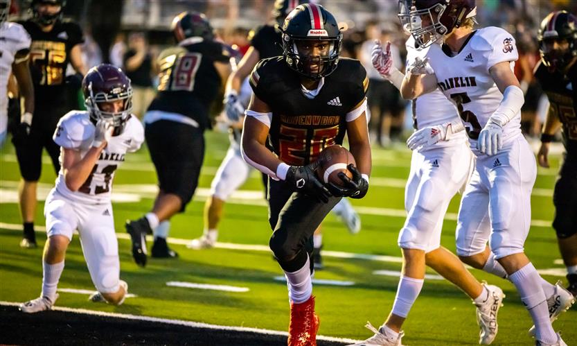 A football player runs on the field